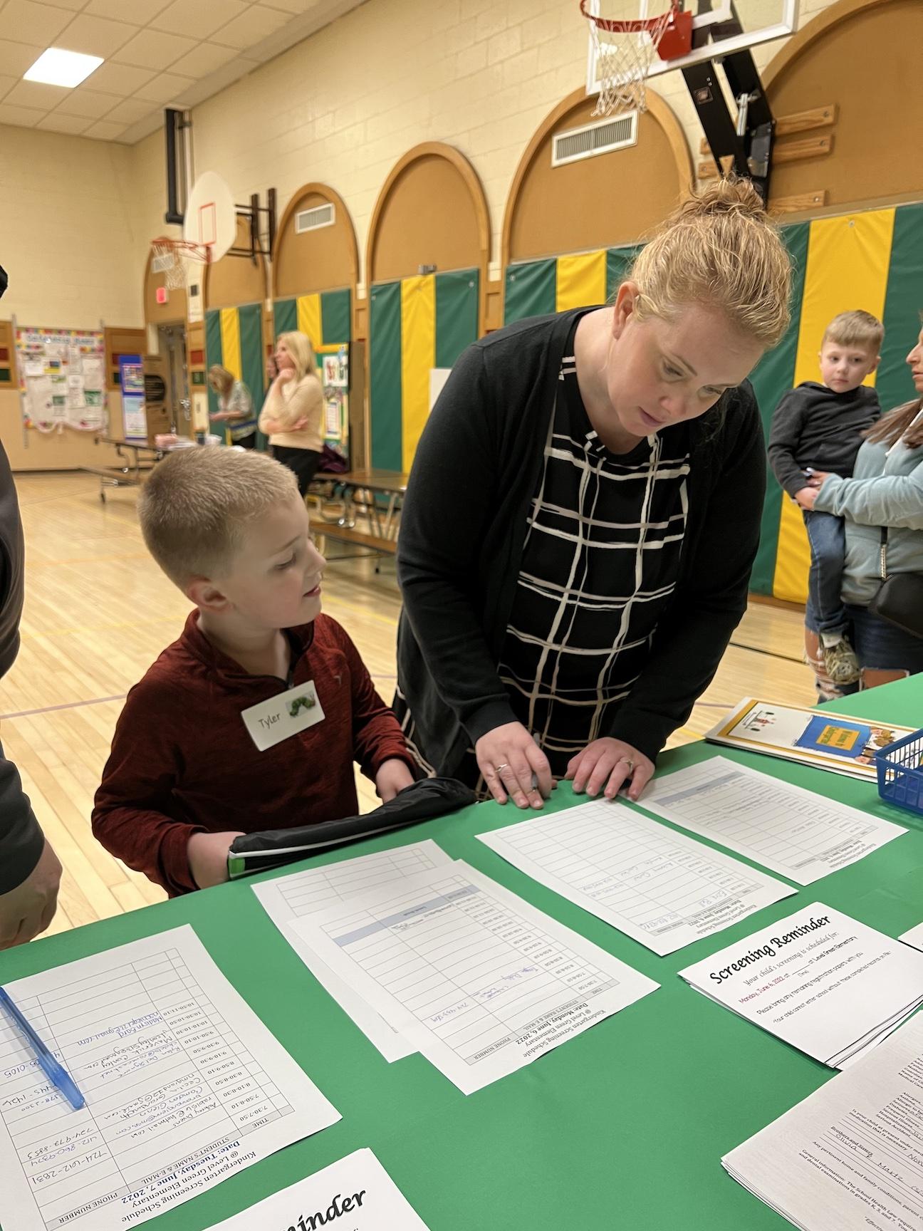 Tyler Martz and his mother sign up for a screening at Level Green Elementary