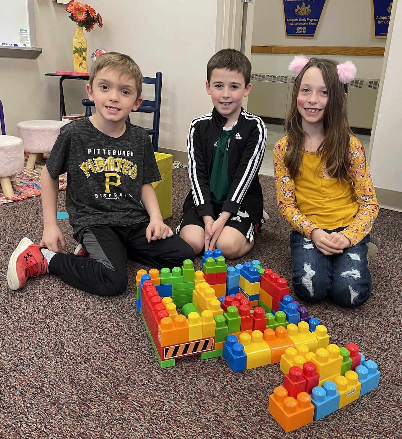 Anthony Cinti, Blake Savinda, and Lily King worked together to build this school using blocks