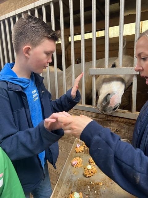 5th-grader Caad Costelnock feeds some treats to his new friend