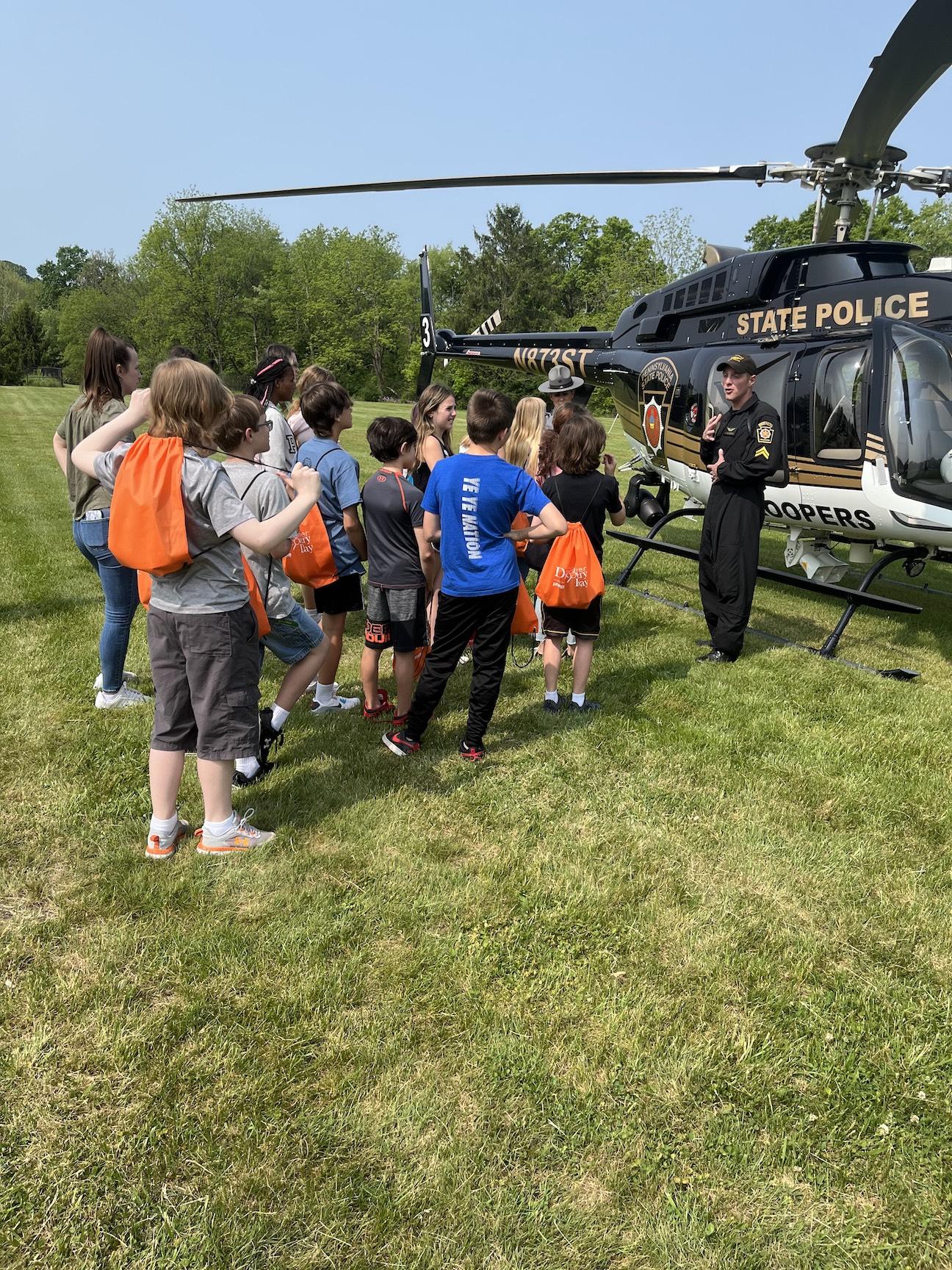 State Police officers talk to some Trafford Elementary students
