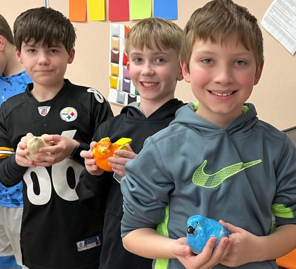 Sunrise Elementary 4th-graders Jordan McLaughlin, Parker Loughner, and Jesse Kurisko hold their clay bird sculptures