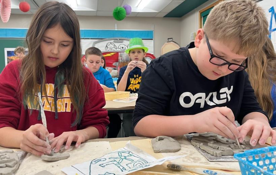 McCullough 5th-graders Lily Milko and Owen Dandar sculpt clay face projects