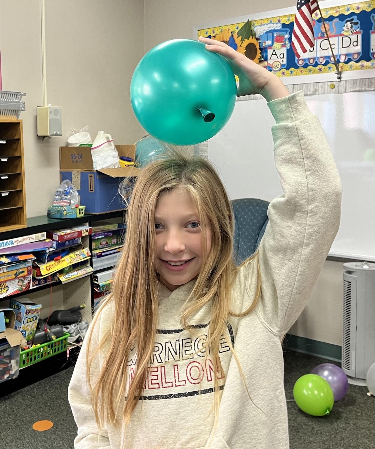 4th-grader Anna Gambone demonstrates static electricity